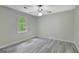 Bright bedroom with gray walls, a ceiling fan, and a large window at 180 Bentley Way, Fayetteville, GA 30214