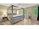 Cozy bedroom with a four-poster bed, ceiling fan, and two large windows for natural light at 180 Bentley Way, Fayetteville, GA 30214