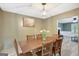 This beautiful dining room boasts a classic lantern light fixture above a wooden dining table with seating for six at 180 Bentley Way, Fayetteville, GA 30214