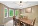 Elegant dining room featuring a wooden table, six chairs, and bay windows offering scenic outdoor views at 180 Bentley Way, Fayetteville, GA 30214