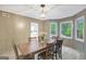 Well-lit dining room showcasing a wooden table, chairs, and a bay window offering a view of the outdoors at 180 Bentley Way, Fayetteville, GA 30214