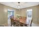 Inviting dining room with a wooden table and six chairs, complemented by natural light and open access to other rooms at 180 Bentley Way, Fayetteville, GA 30214
