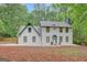 Stunning two-story home featuring a white brick exterior and a beautifully landscaped front yard at 180 Bentley Way, Fayetteville, GA 30214
