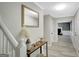Inviting hallway with decoratively adorned console table and view of living room at 180 Bentley Way, Fayetteville, GA 30214
