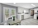 Bright kitchen features white cabinets, stainless steel appliances, and sliding glass doors to the backyard deck at 180 Bentley Way, Fayetteville, GA 30214