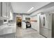 Open kitchen with white cabinets, stainless steel appliances, and a view into the dining room at 180 Bentley Way, Fayetteville, GA 30214