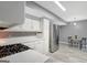Spacious kitchen with white cabinets, stainless steel appliances, and an adjacent dining area at 180 Bentley Way, Fayetteville, GA 30214