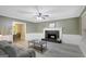 Comfortable living room featuring a fireplace, neutral wall colors, and a seamless flow to the dining area at 180 Bentley Way, Fayetteville, GA 30214