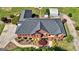 Birds-eye view of brick house, landscaped yard, circular driveway, and detached garage at 220 Edna Ruth Ln, Mcdonough, GA 30253