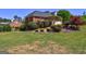 Lush backyard featuring mature landscaping and green lawn, complemented by a brick home exterior at 220 Edna Ruth Ln, Mcdonough, GA 30253
