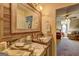Bathroom featuring granite countertops, wood paneled mirror, decorative fixtures, and an open door to a bedroom at 220 Edna Ruth Ln, Mcdonough, GA 30253