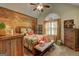 Cozy bedroom featuring a wooden accent wall, ceiling fan, and a charming window with stylish curtains at 220 Edna Ruth Ln, Mcdonough, GA 30253