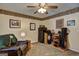 Bonus room with golf themed decor, safe, ceiling fan, wood trim, and comfortable seating at 220 Edna Ruth Ln, Mcdonough, GA 30253