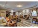 Large living room with wooden floors, tray ceiling, recessed lighting, comfortable seating, and fireplace at 220 Edna Ruth Ln, Mcdonough, GA 30253