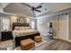 Spacious main bedroom with tray ceiling, ceiling fan, neutral decor, and dark wood furnishings at 220 Edna Ruth Ln, Mcdonough, GA 30253