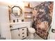Well decorated bathroom with a new vanity, new black framed mirror and updated shower at 120 Trisha Ln, Grantville, GA 30220