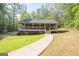 Exterior view of a charming home with a covered porch and well-maintained landscaping at 120 Trisha Ln, Grantville, GA 30220