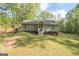 The exterior elevation features light green siding and is surrounded by a large lawn at 120 Trisha Ln, Grantville, GA 30220