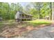Ranch-style home features a covered front porch and a lush tree lined yard at 120 Trisha Ln, Grantville, GA 30220
