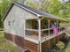 Charming single-story home featuring a spacious front porch with rocking chair and well-maintained lawn at 120 Trisha Ln, Grantville, GA 30220