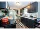 Well-lit kitchen with stainless steel appliances, dark cabinetry, and light countertops at 120 Trisha Ln, Grantville, GA 30220