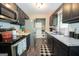Charming kitchen featuring stainless steel appliances and stylish dark cabinets at 120 Trisha Ln, Grantville, GA 30220