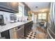 Modern kitchen featuring black cabinets, stainless steel appliances, and granite countertops at 120 Trisha Ln, Grantville, GA 30220
