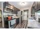 Modern kitchen with stainless steel appliances, updated countertops, and stylish black cabinetry at 120 Trisha Ln, Grantville, GA 30220