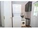 A bright laundry area with washer and dryer, shelving and door to the outside at 120 Trisha Ln, Grantville, GA 30220