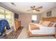 Primary bedroom with a ceiling fan, dresser, TV, and neutral decor at 120 Trisha Ln, Grantville, GA 30220