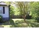 Fenced-in backyard with some landscaping and mature trees at 4793 Davenport Nw Trce, Acworth, GA 30101