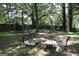 Backyard featuring mature trees providing ample shade, a trampoline, and metal patio furniture at 4793 Davenport Nw Trce, Acworth, GA 30101