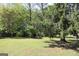 Open backyard with green grass and mature trees at 4793 Davenport Nw Trce, Acworth, GA 30101