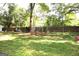 Backyard featuring mature trees and a partially visible trampoline and other outdoor recreational items at 4793 Davenport Nw Trce, Acworth, GA 30101