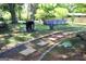 Backyard featuring a stone pathway leading to an above ground pool, grill, and outdoor seating area at 4793 Davenport Nw Trce, Acworth, GA 30101