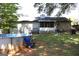 View of the backyard showcasing a partial above-ground pool, screened porch, and well-maintained lawn at 4793 Davenport Nw Trce, Acworth, GA 30101
