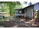 Backyard featuring a stone pathway leading to a screened porch area of the house at 4793 Davenport Nw Trce, Acworth, GA 30101