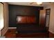Bedroom featuring a dark accent wall, wood-frame bed, and an adjacent closet space at 4793 Davenport Nw Trce, Acworth, GA 30101