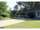 Long driveway with a carport to the right of a single-story home and lots of trees at 4793 Davenport Nw Trce, Acworth, GA 30101