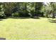 Home with a well-maintained lawn, surrounded by mature trees and landscaping at 4793 Davenport Nw Trce, Acworth, GA 30101