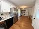 Bright kitchen features stainless steel refrigerator and white cabinets plus an adjacent laundry area at 4793 Davenport Nw Trce, Acworth, GA 30101