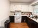 Galley kitchen featuring white cabinets, stainless steel refrigerator, and hardwood floors at 4793 Davenport Nw Trce, Acworth, GA 30101