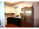 Galley kitchen featuring white cabinets, stainless steel refrigerator, and hardwood floors at 4793 Davenport Nw Trce, Acworth, GA 30101