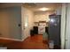 Kitchen featuring white cabinets, stainless steel refrigerator, and hardwood floors at 4793 Davenport Nw Trce, Acworth, GA 30101