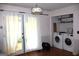 Bright laundry area featuring a pair of modern washing machines, storage shelves, and convenient access to the outdoors at 4793 Davenport Nw Trce, Acworth, GA 30101