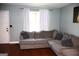 Comfortable living room with a large grey couch, white curtains, and natural light at 4793 Davenport Nw Trce, Acworth, GA 30101