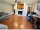 Spacious living room showcasing a fireplace and hardwood floors, plus comfortable seating at 4793 Davenport Nw Trce, Acworth, GA 30101