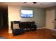 Relaxing living room boasts hardwood floors, television, and a blue armchair at 4793 Davenport Nw Trce, Acworth, GA 30101