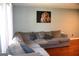 Cozy living room featuring a large grey sectional couch and a lion art piece on the wall at 4793 Davenport Nw Trce, Acworth, GA 30101