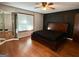 Large bedroom with wood flooring, a ceiling fan, and a closet at 4793 Davenport Nw Trce, Acworth, GA 30101